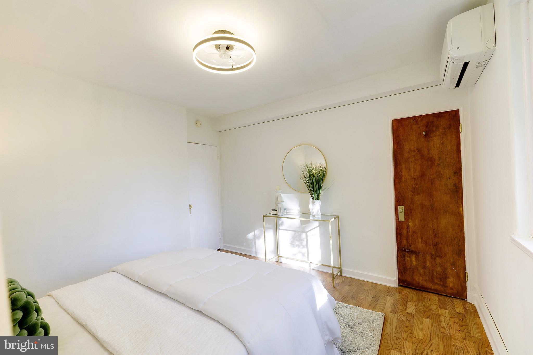 10 Hillside Road Greenbelt, MD 20770 - Photo 36 of 50 a bedroom with a bed and a chandelier