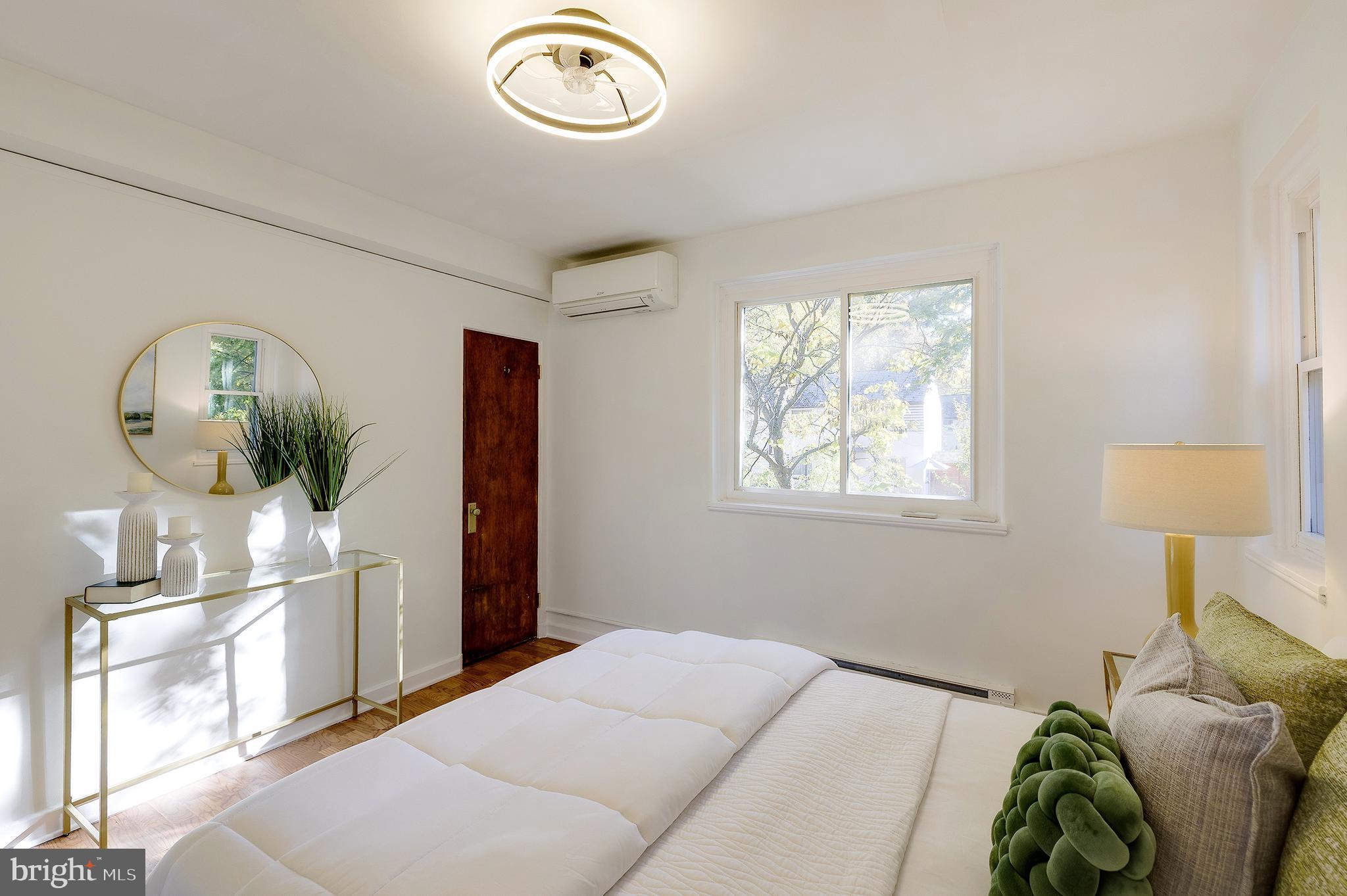 10 Hillside Road Greenbelt, MD 20770 - Photo 37 of 50 a bedroom with a bed and a chandelier