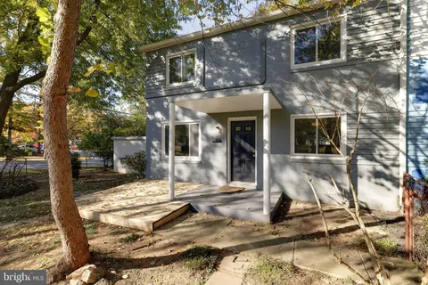 a view of a house with backyard porch and sitting area