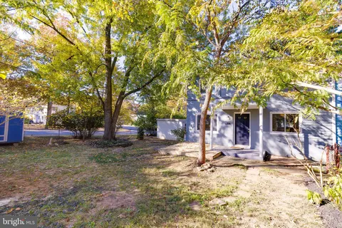a view of a house with a yard covered in snow