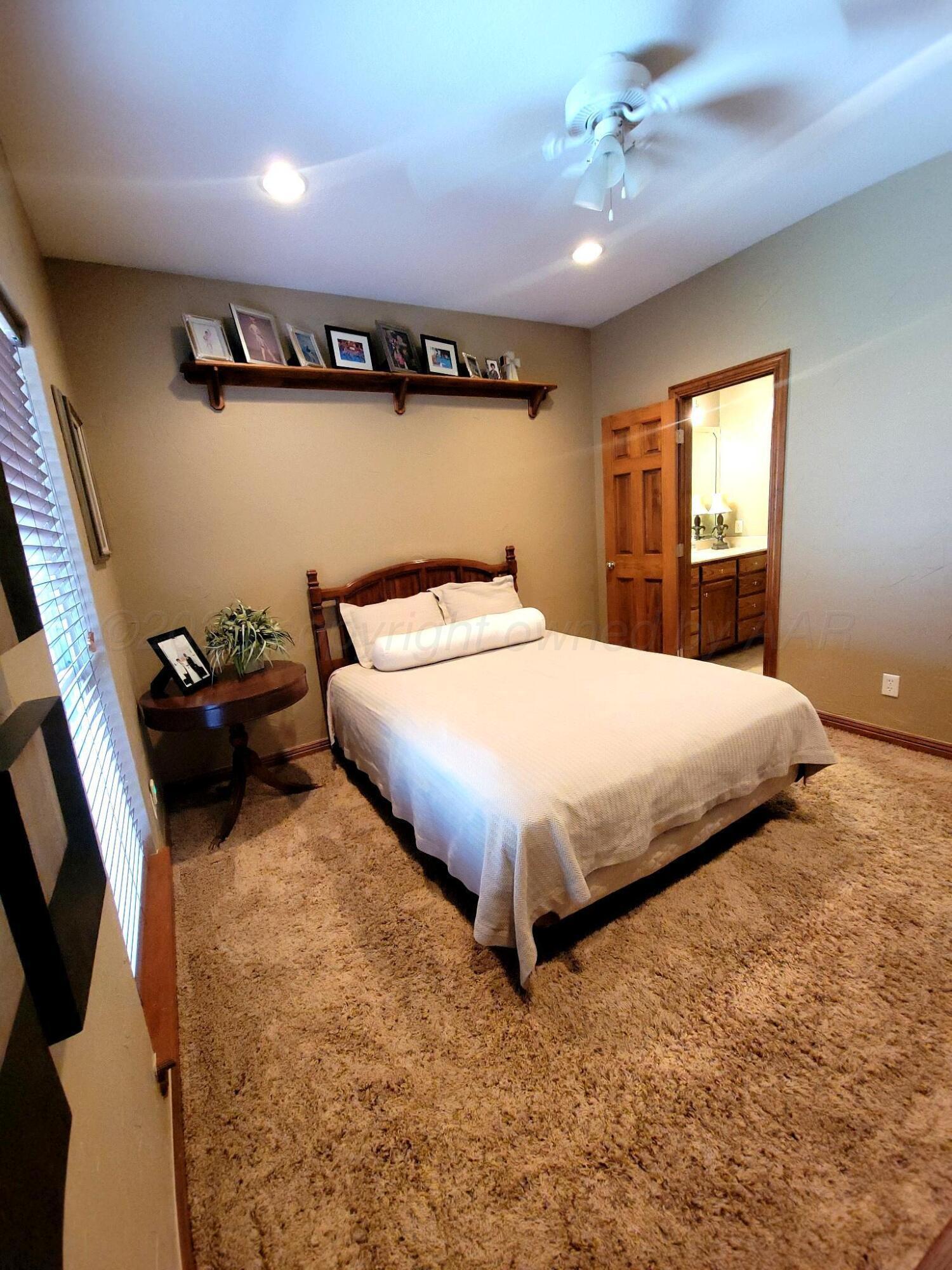 14355 Southeast Se Loop Perryton, TX 79070 - Photo 14 of 33 a bedroom with a bed and a window