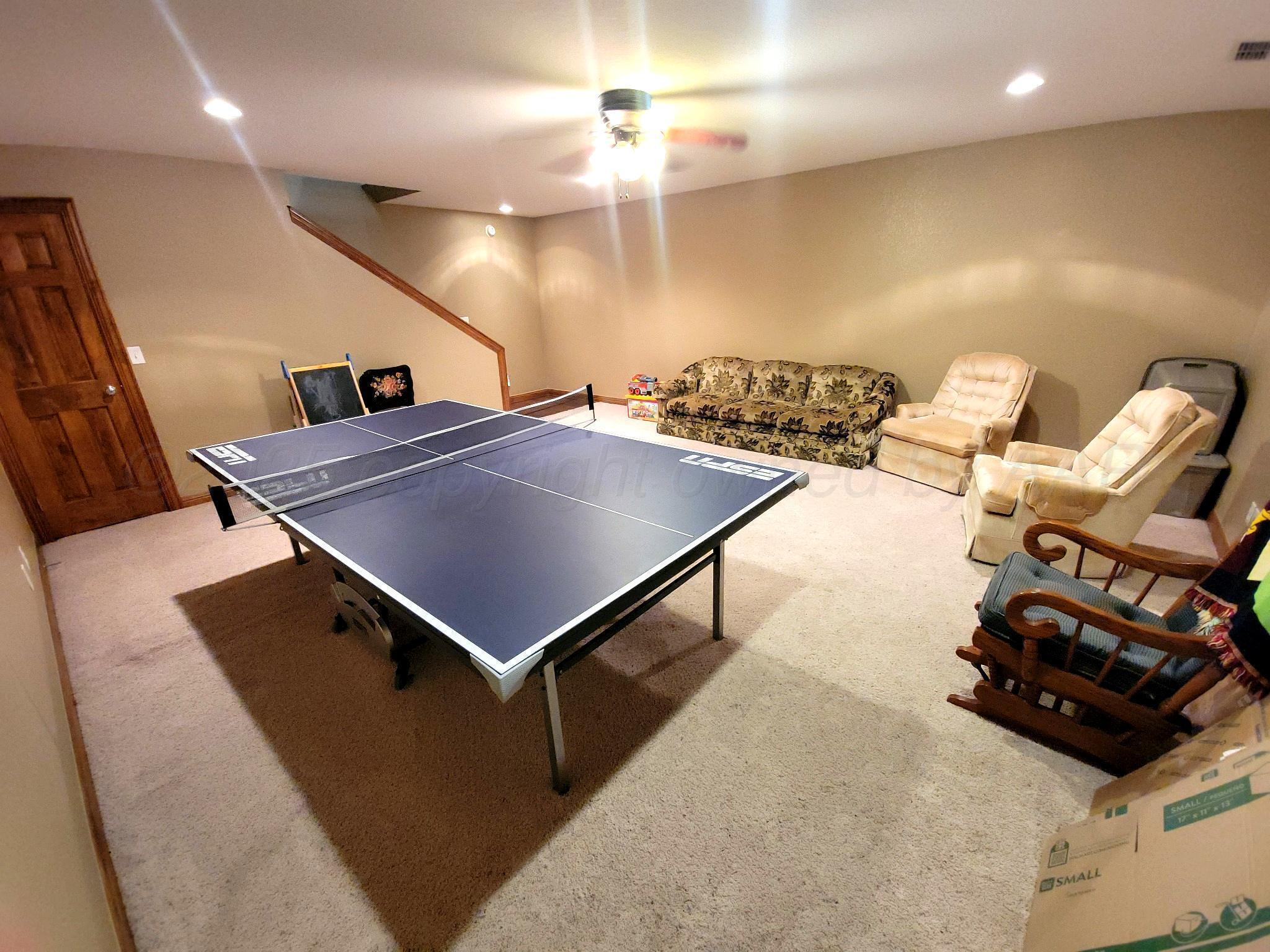 14355 Southeast Se Loop Perryton, TX 79070 - Photo 22 of 33 a living room with furniture and a chandelier