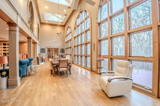 a living room with furniture a flat screen tv and wooden floor
