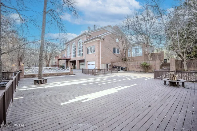 a open kitchen with wooden floors and glass table
