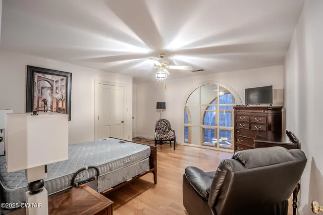 a view of a dry yard with wooden fence