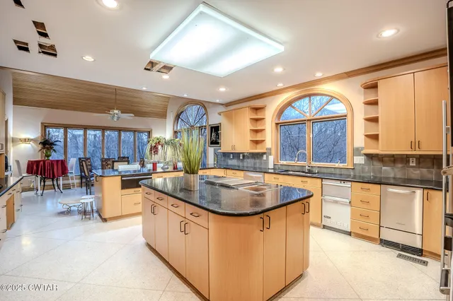 a kitchen with stainless steel appliances granite countertop a sink and stove