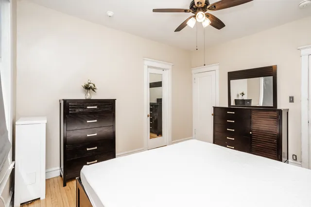 a bedroom with a bed and a dresser