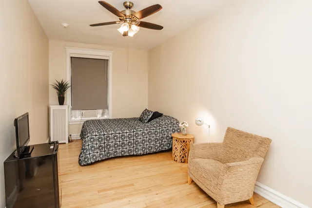 a bedroom with a bed and a couch