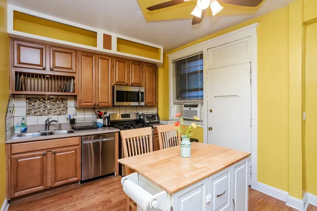 a kitchen with a sink a stove and cabinets