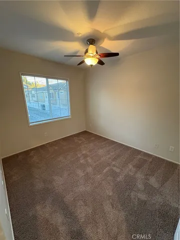 a view of a balcony with chairs and wooden fence