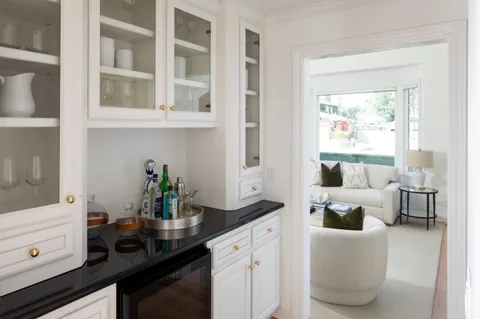 a kitchen with a sink and living room