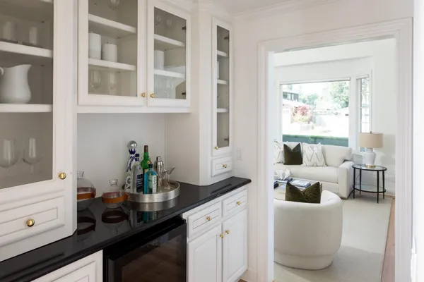 a kitchen with a sink and living room