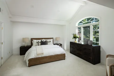 a bedroom with a bed and window