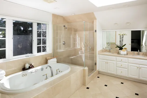a bathroom with a tub sink and mirror