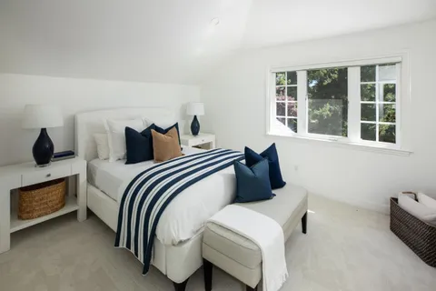 a bedroom with bed and a window