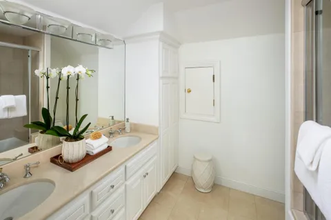 a bathroom with a sink a mirror and a shower curtain