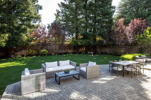a view of a table and chairs in the garden