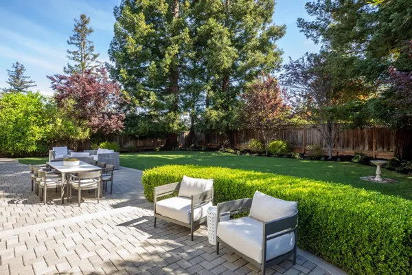 a view of backyard with seating area and green space