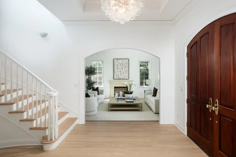 a view of a livingroom with furniture a ceiling fan and windows