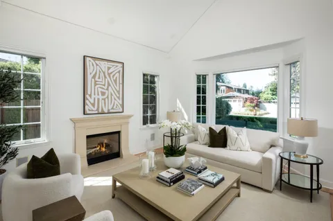 a living room with furniture fireplace and window