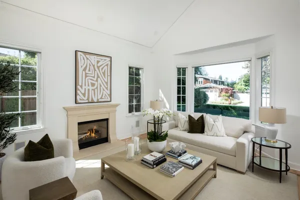 a living room with furniture fireplace and window