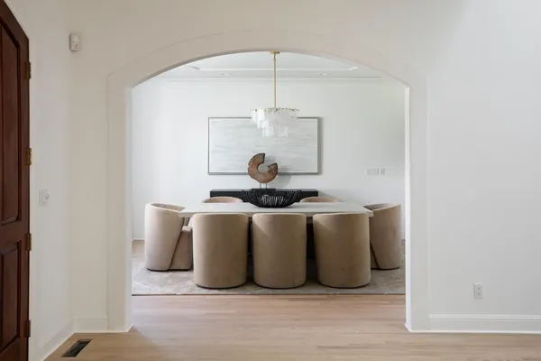 a room with a table and chandelier