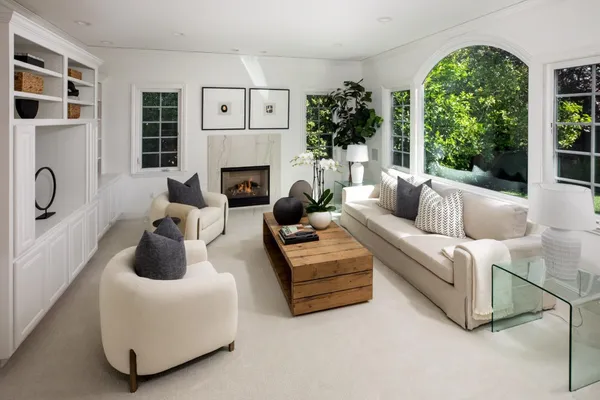 a living room with furniture and a fireplace
