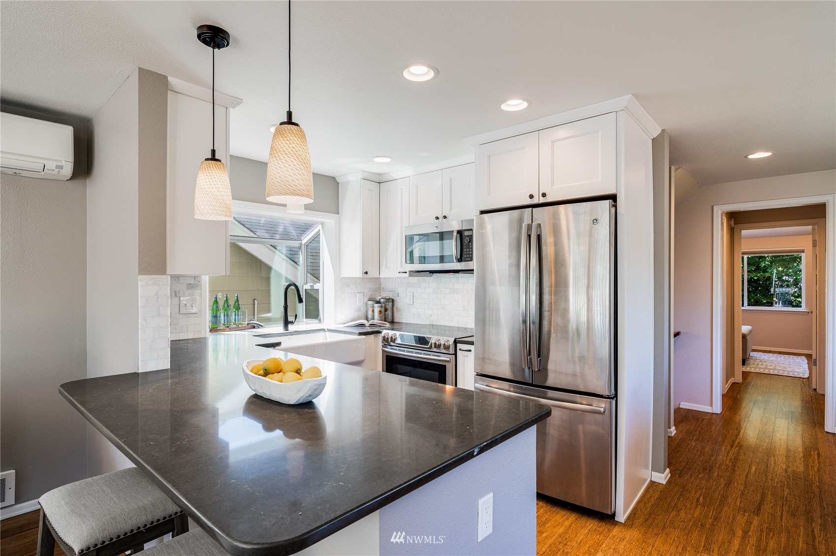 548 North 75th Street Seattle, WA 98103 - Photo 13 of 39 a kitchen with stainless steel appliances granite countertop a sink a refrigerator and a stove