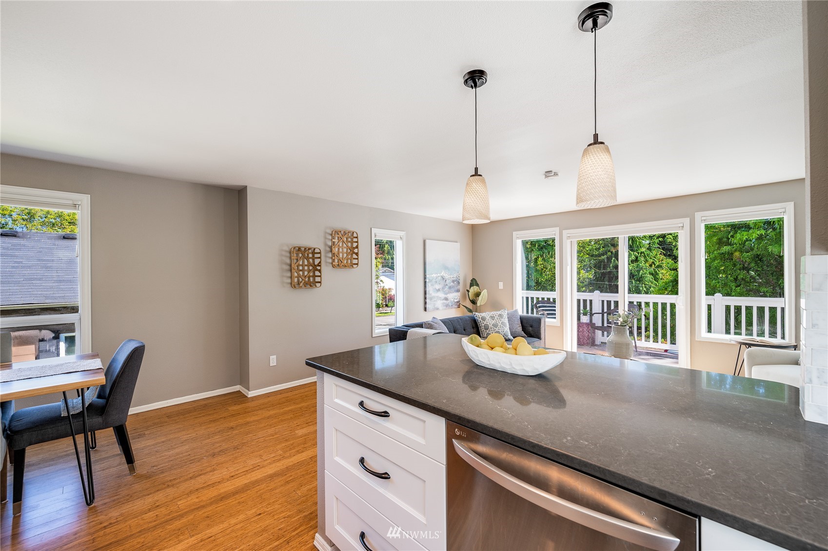 548 North 75th Street Seattle, WA 98103 - Photo 14 of 39 a kitchen with a sink dining table and chairs