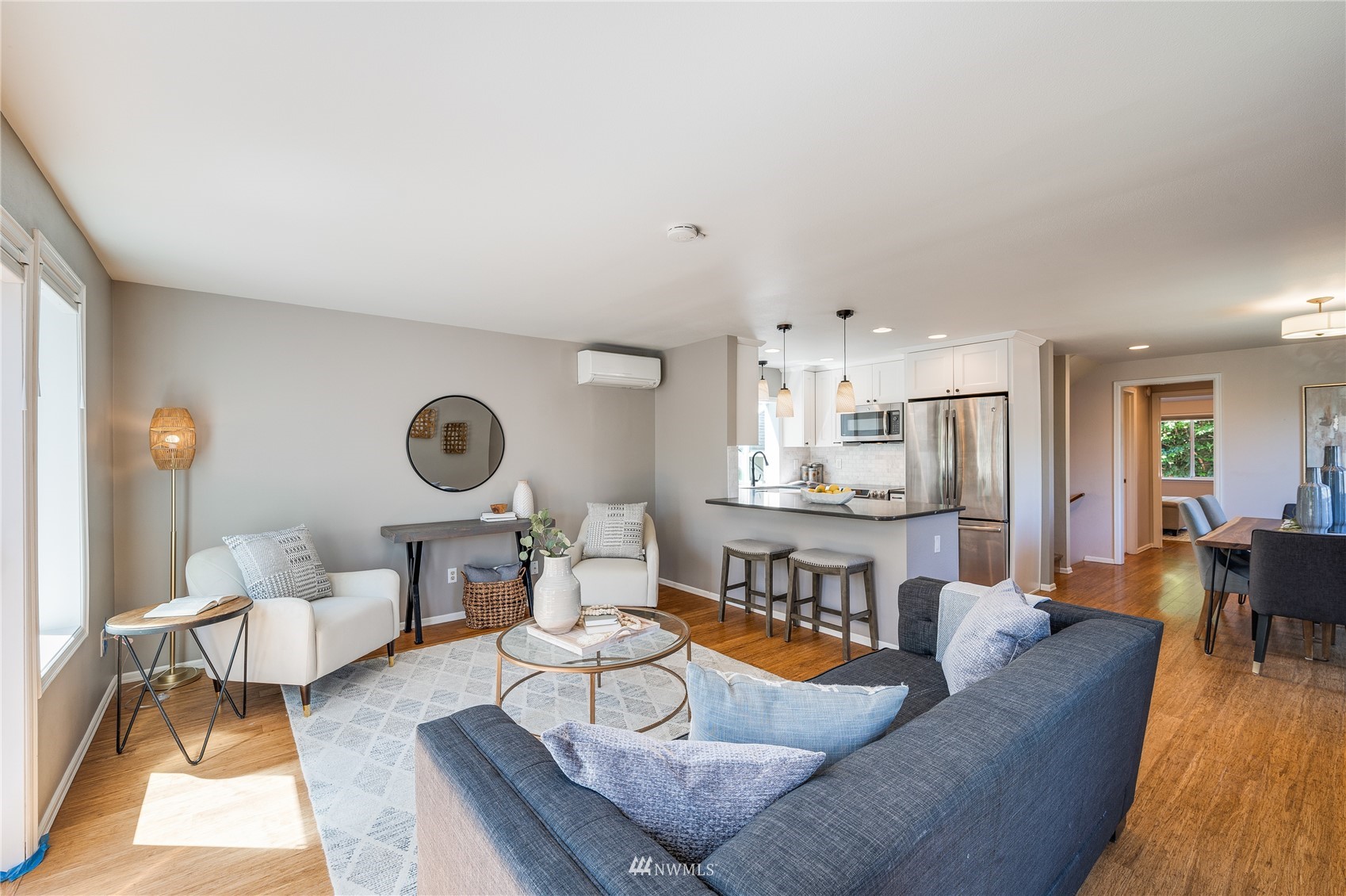 548 North 75th Street Seattle, WA 98103 - Photo 19 of 39 a living room with furniture a rug and kitchen view