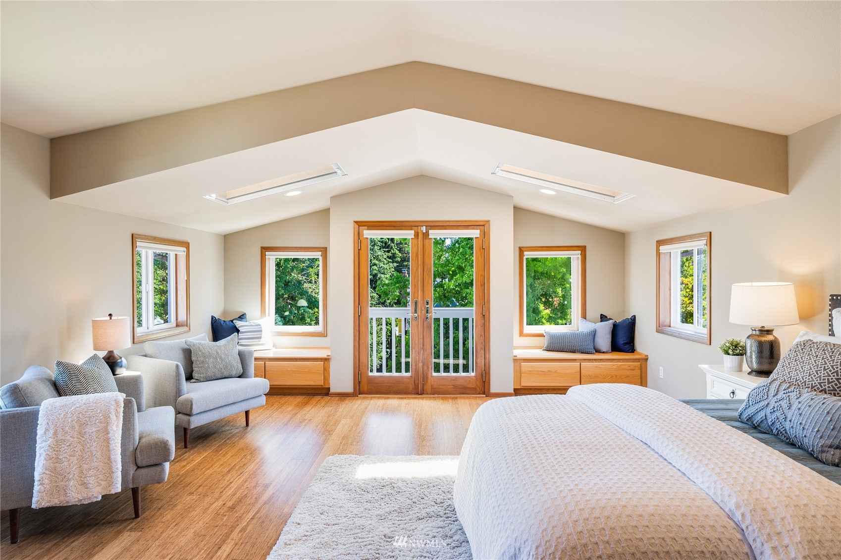 548 North 75th Street Seattle, WA 98103 - Photo 2 of 39 a spacious bedroom with a large bed couch and a large window