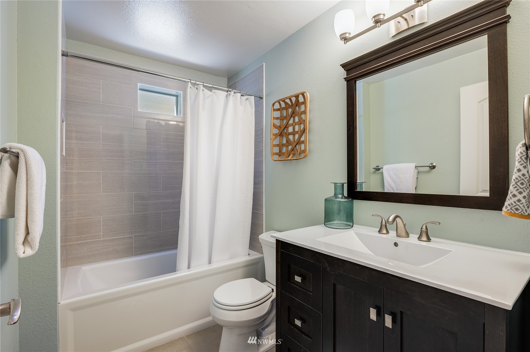 548 North 75th Street Seattle, WA 98103 - Photo 31 of 39 a bathroom with a sink a toilet and shower