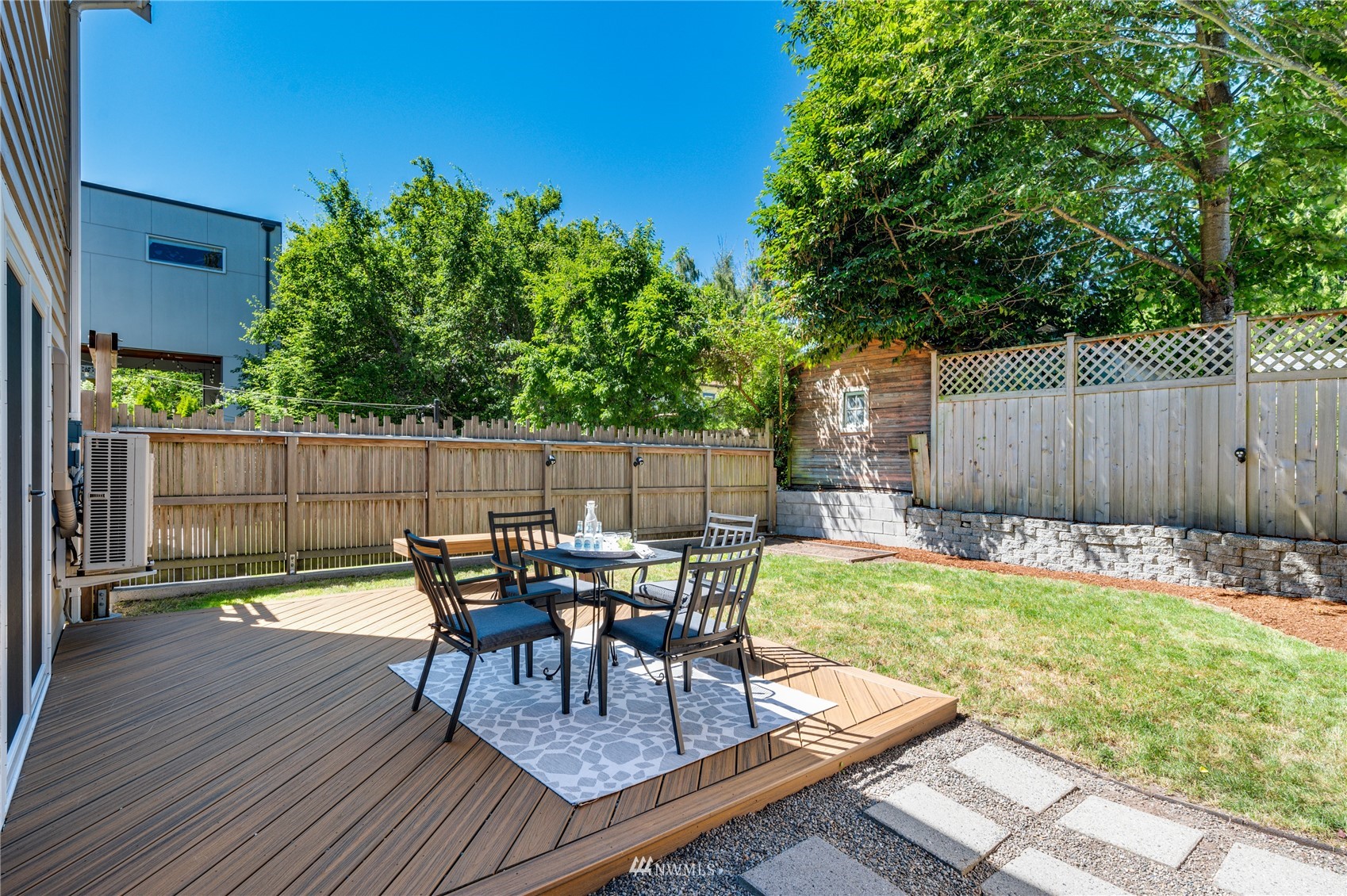 548 North 75th Street Seattle, WA 98103 - Photo 32 of 39 a view of a chairs and table in patio with wooden fence