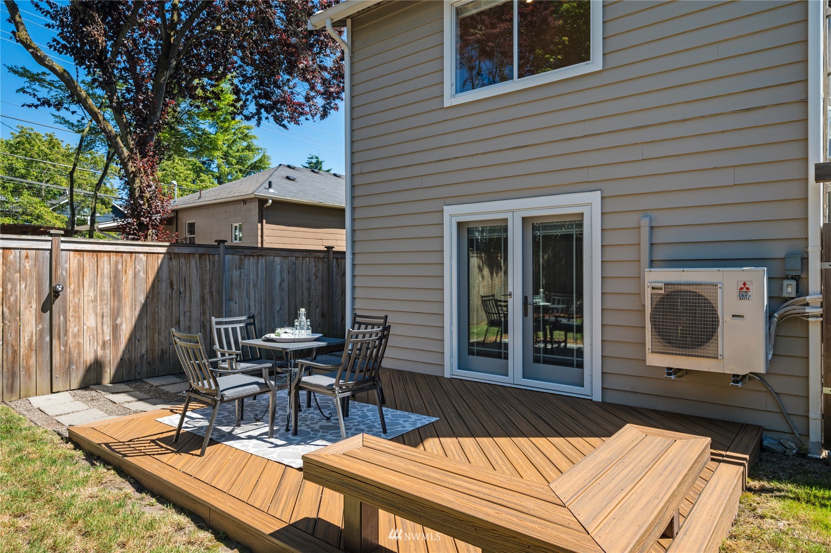 548 North 75th Street Seattle, WA 98103 - Photo 33 of 39 a view of a patio with table and chairs with wooden floor and fence