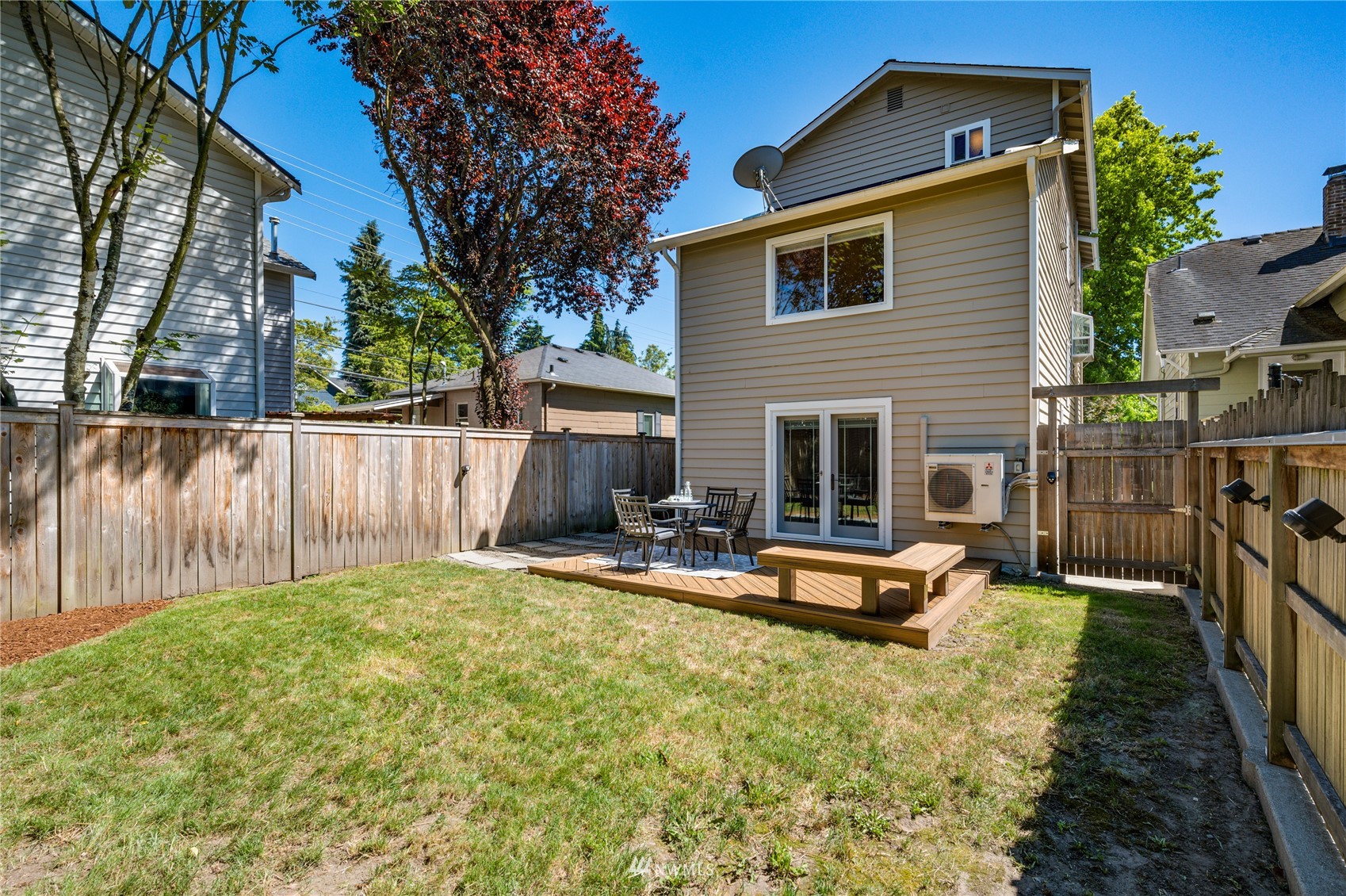 548 North 75th Street Seattle, WA 98103 - Photo 34 of 39 a backyard of a house with table and chairs