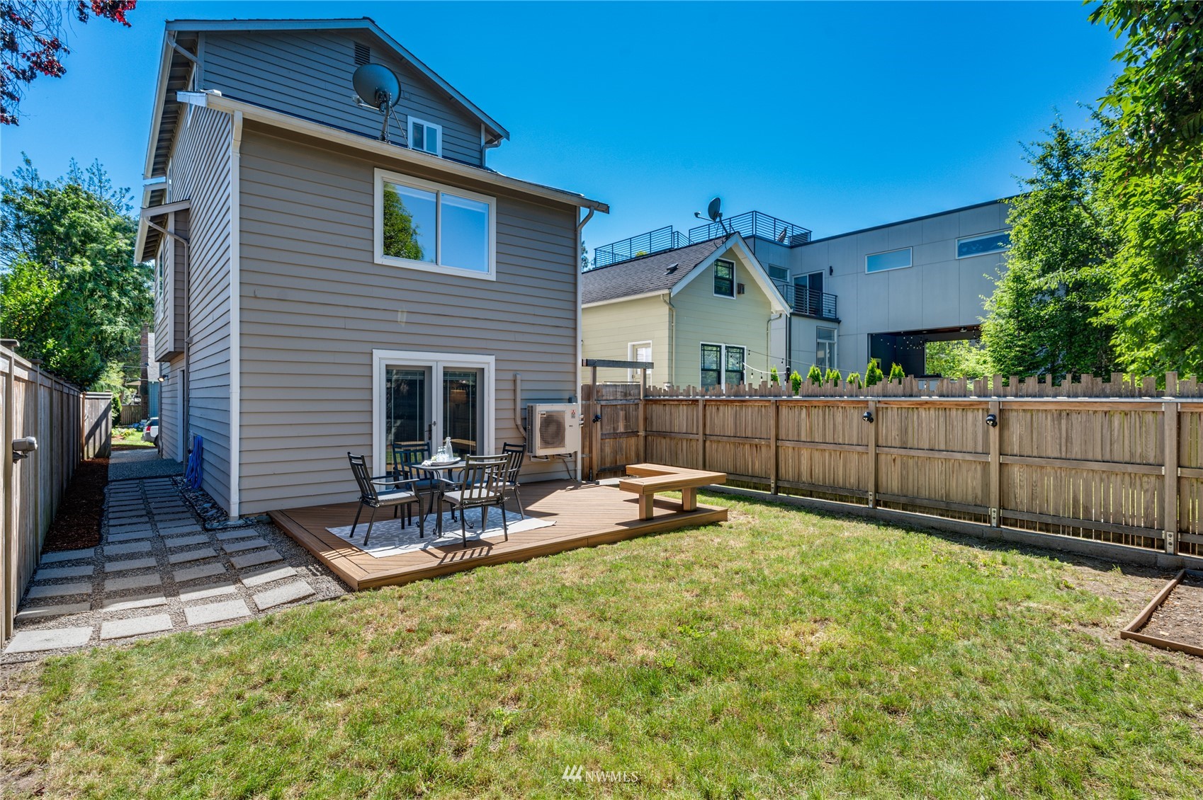 548 North 75th Street Seattle, WA 98103 - Photo 35 of 39 a view of backyard with wooden fence and a large tree