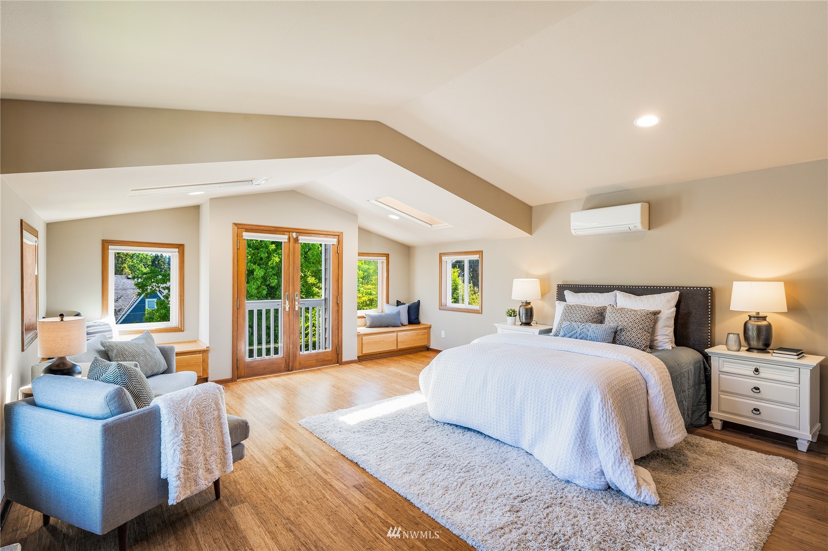 548 North 75th Street Seattle, WA 98103 - Photo 4 of 39 a spacious bedroom with a bed and glass windows