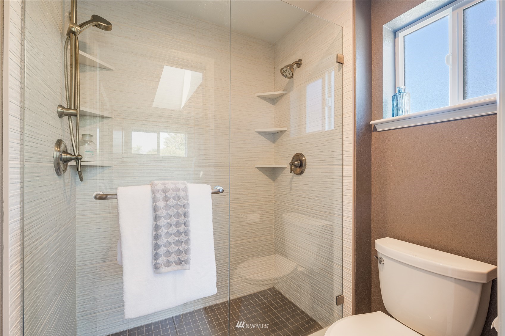 548 North 75th Street Seattle, WA 98103 - Photo 10 of 39 a bathroom with a toilet and a shower
