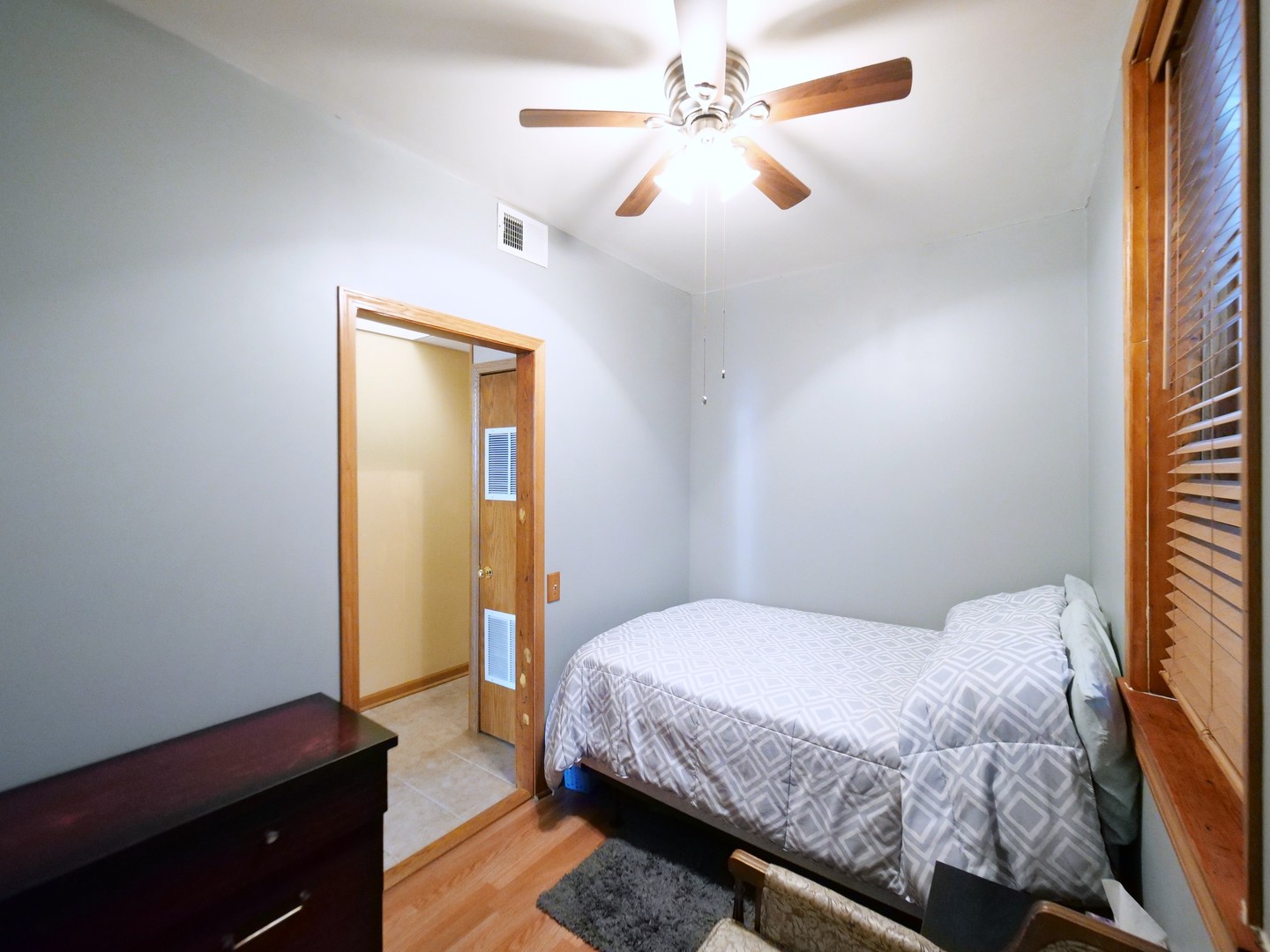 4556 South Justine Street Chicago, IL 60609 - Photo 16 of 50 a bedroom with a bed and a dresser