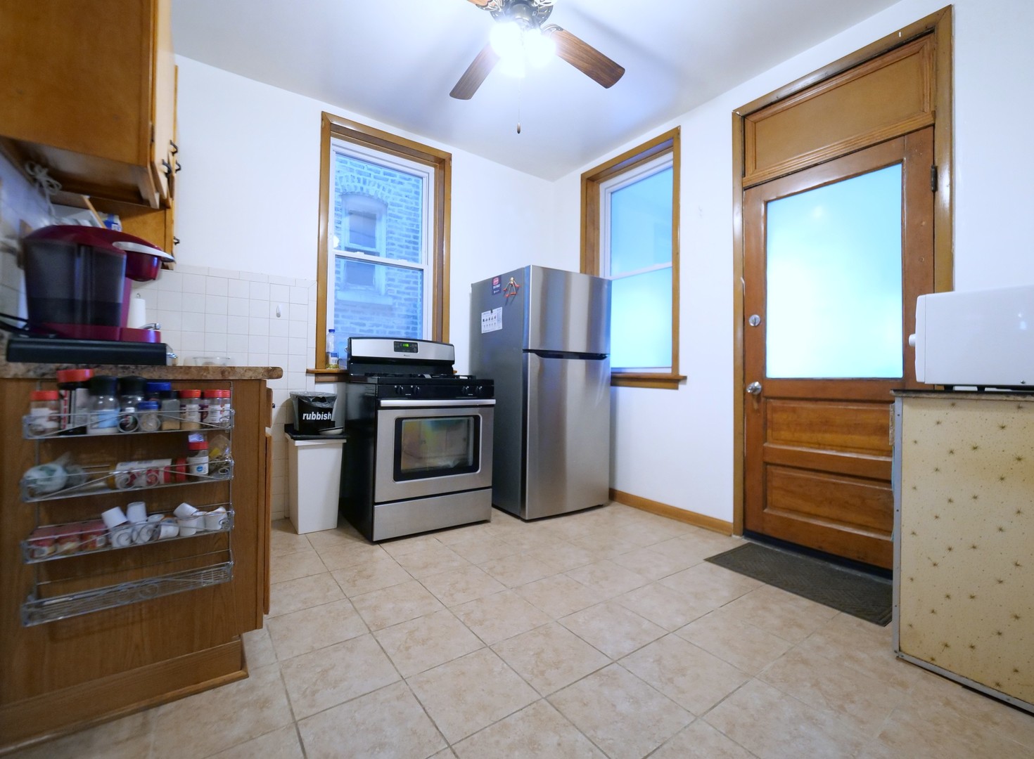 4556 South Justine Street Chicago, IL 60609 - Photo 17 of 50 a kitchen with stainless steel appliances granite countertop a refrigerator and a stove top oven