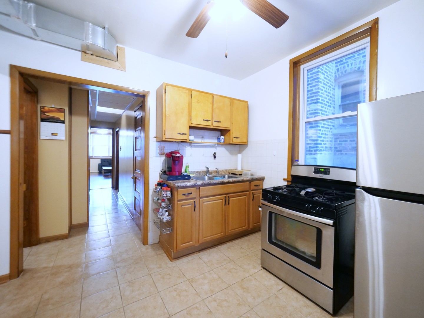 4556 South Justine Street Chicago, IL 60609 - Photo 18 of 50 a kitchen with stainless steel appliances granite countertop a stove and a sink