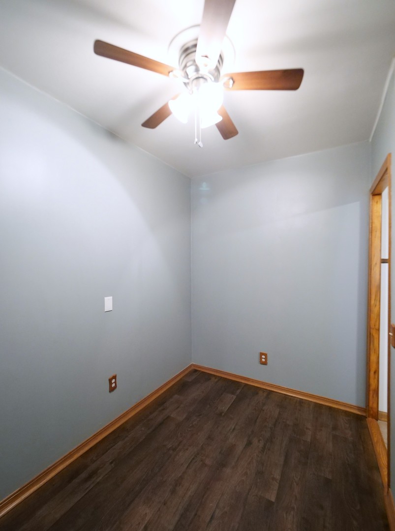 4556 South Justine Street Chicago, IL 60609 - Photo 19 of 50 a view of a room with wooden floor and fan