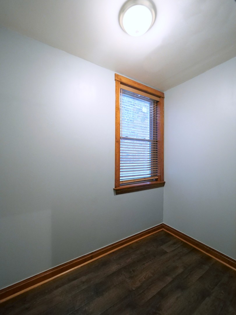 4556 South Justine Street Chicago, IL 60609 - Photo 22 of 50 an empty room with wooden floor and windows