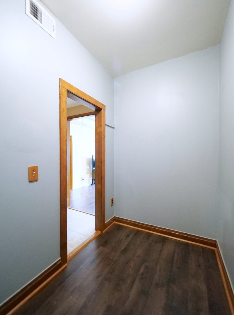 4556 South Justine Street Chicago, IL 60609 - Photo 23 of 50 an empty room with wooden floor and closet