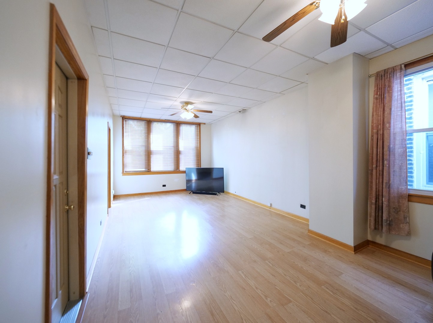 4556 South Justine Street Chicago, IL 60609 - Photo 30 of 50 an empty room with wooden floor and windows