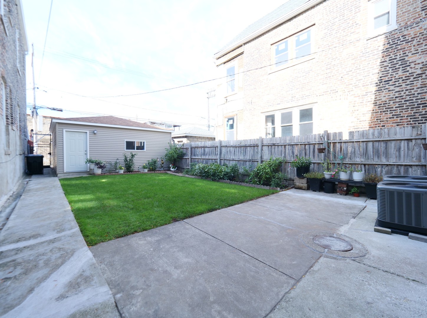 4556 South Justine Street Chicago, IL 60609 - Photo 3 of 50 a view of backyard with porch and outdoor seating