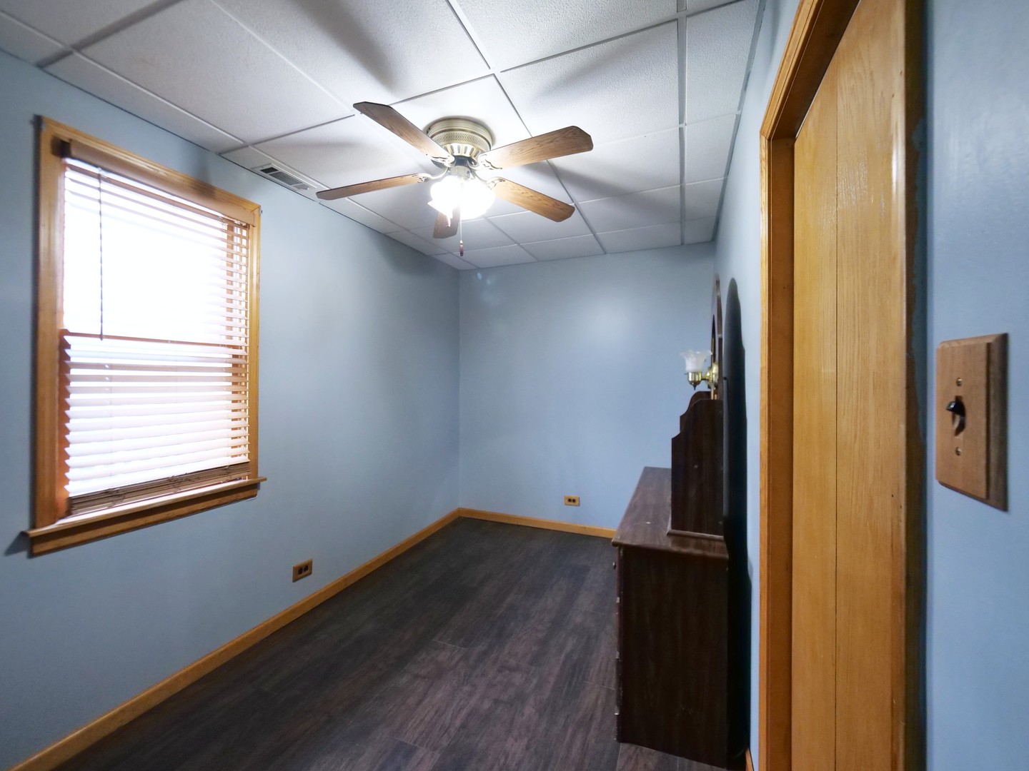 4556 South Justine Street Chicago, IL 60609 - Photo 39 of 50 a view of an empty room with wooden floor and a window