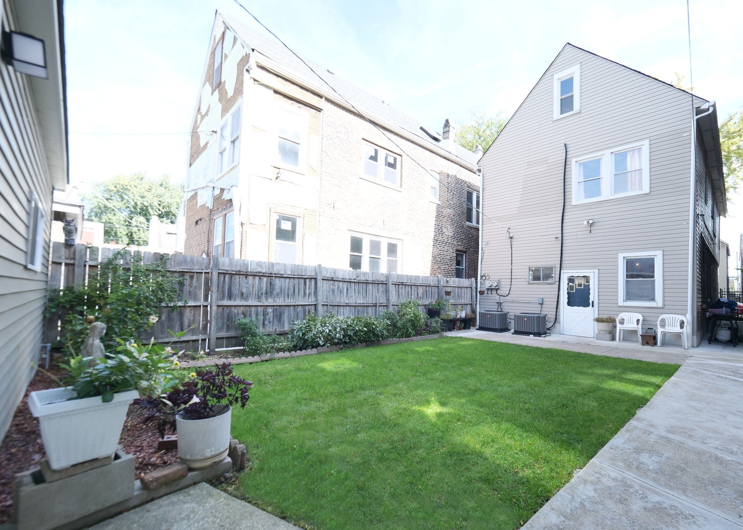 4556 South Justine Street Chicago, IL 60609 - Photo 5 of 50 a view of a house with backyard sitting area and garden