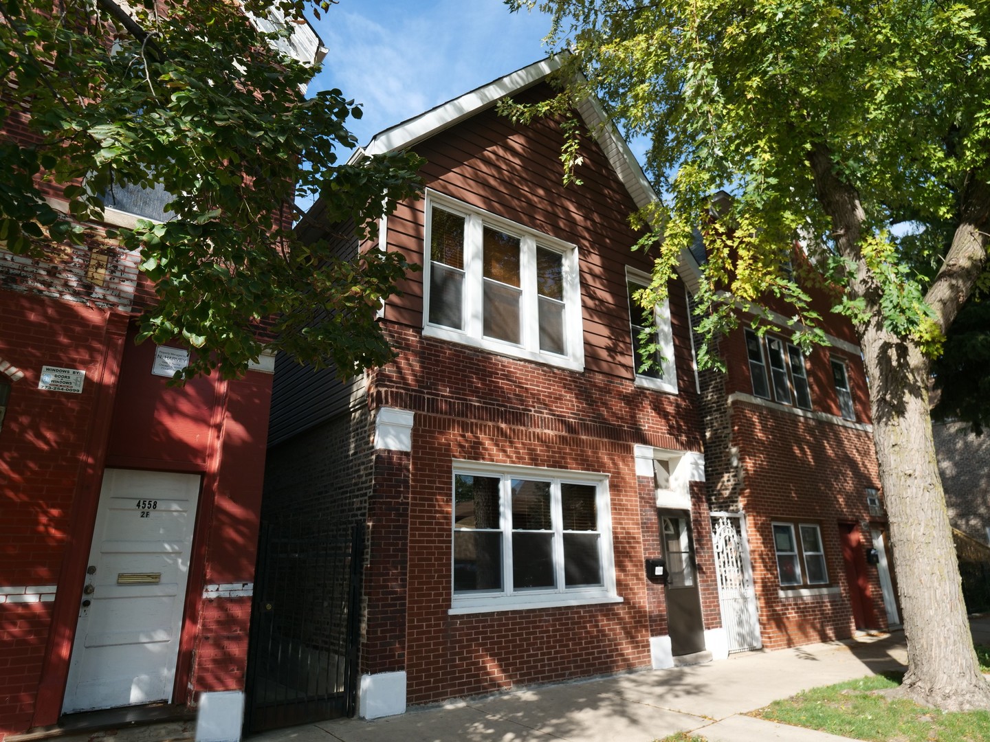 4556 South Justine Street Chicago, IL 60609 - Photo 8 of 50 a front view of a house with a tree