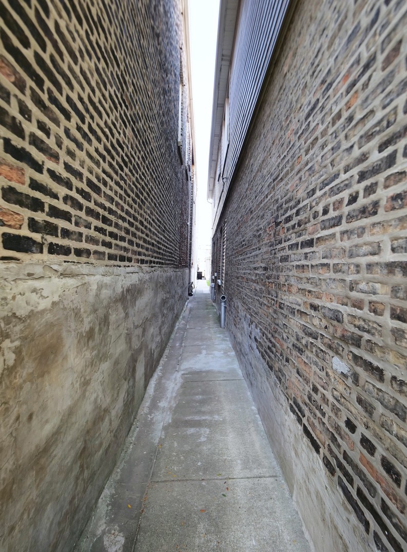 4556 South Justine Street Chicago, IL 60609 - Photo 9 of 50 a view of a pathway both side of building